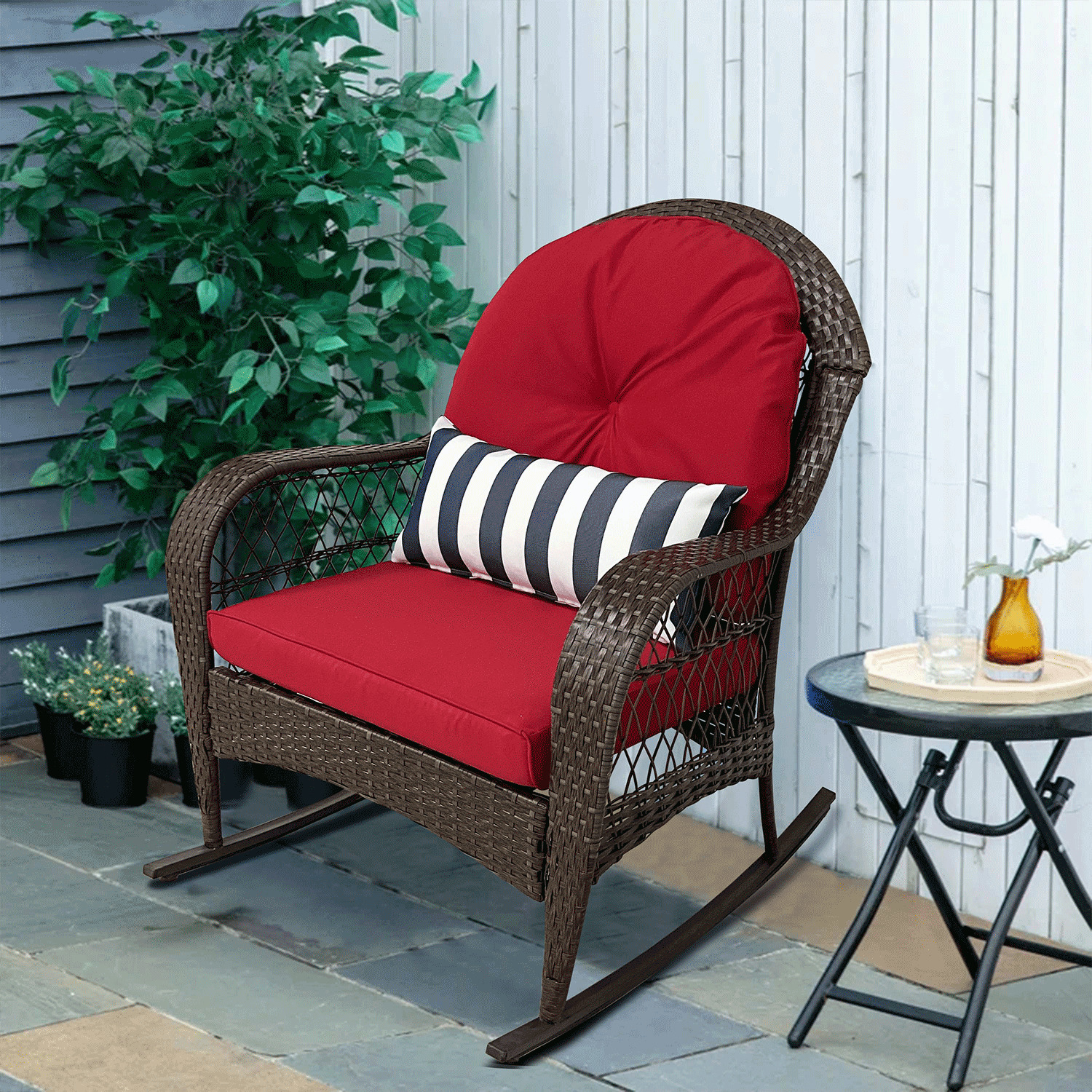 Outdoor rattan rocking chair with red cushions